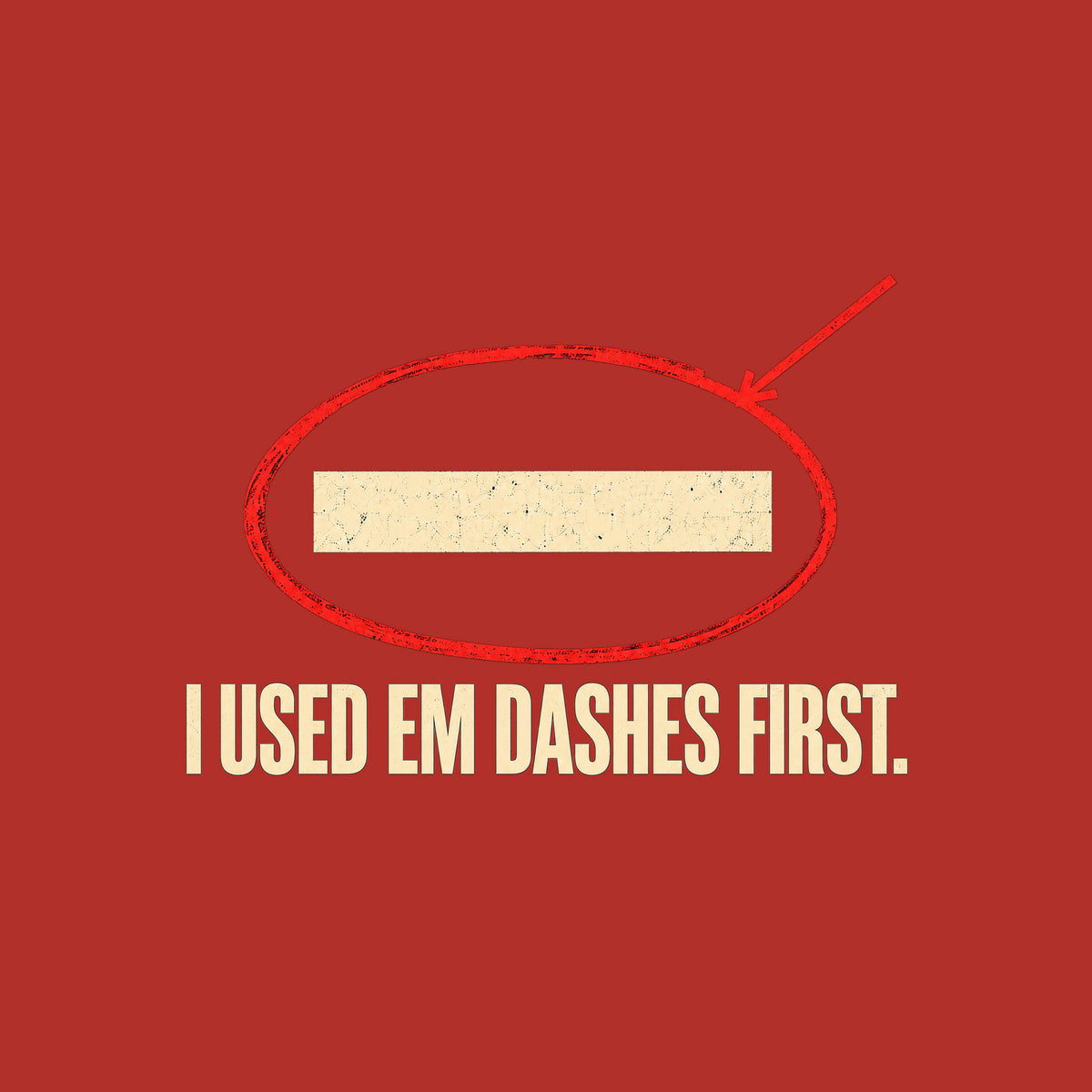 Navy artwork showing a cream em dash circled in red ink with a red leader line pointing to it, above bold cream uppercase text reading I USED EM DASHES FIRST. Artwork shown on the Red garment colour.