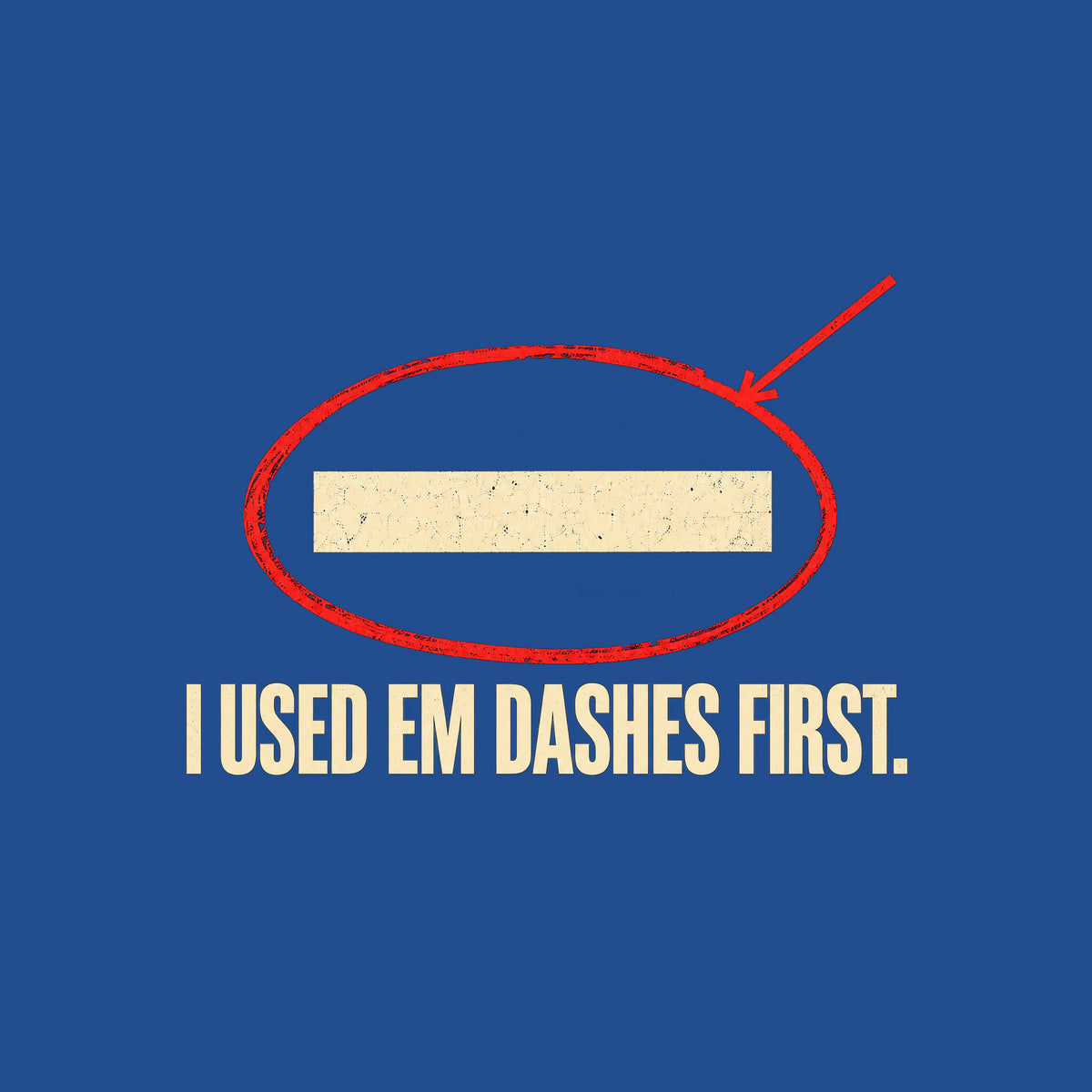 Navy artwork showing a cream em dash circled in red ink with a red leader line pointing to it, above bold cream uppercase text reading I USED EM DASHES FIRST. Artwork shown on the Royal garment colour.