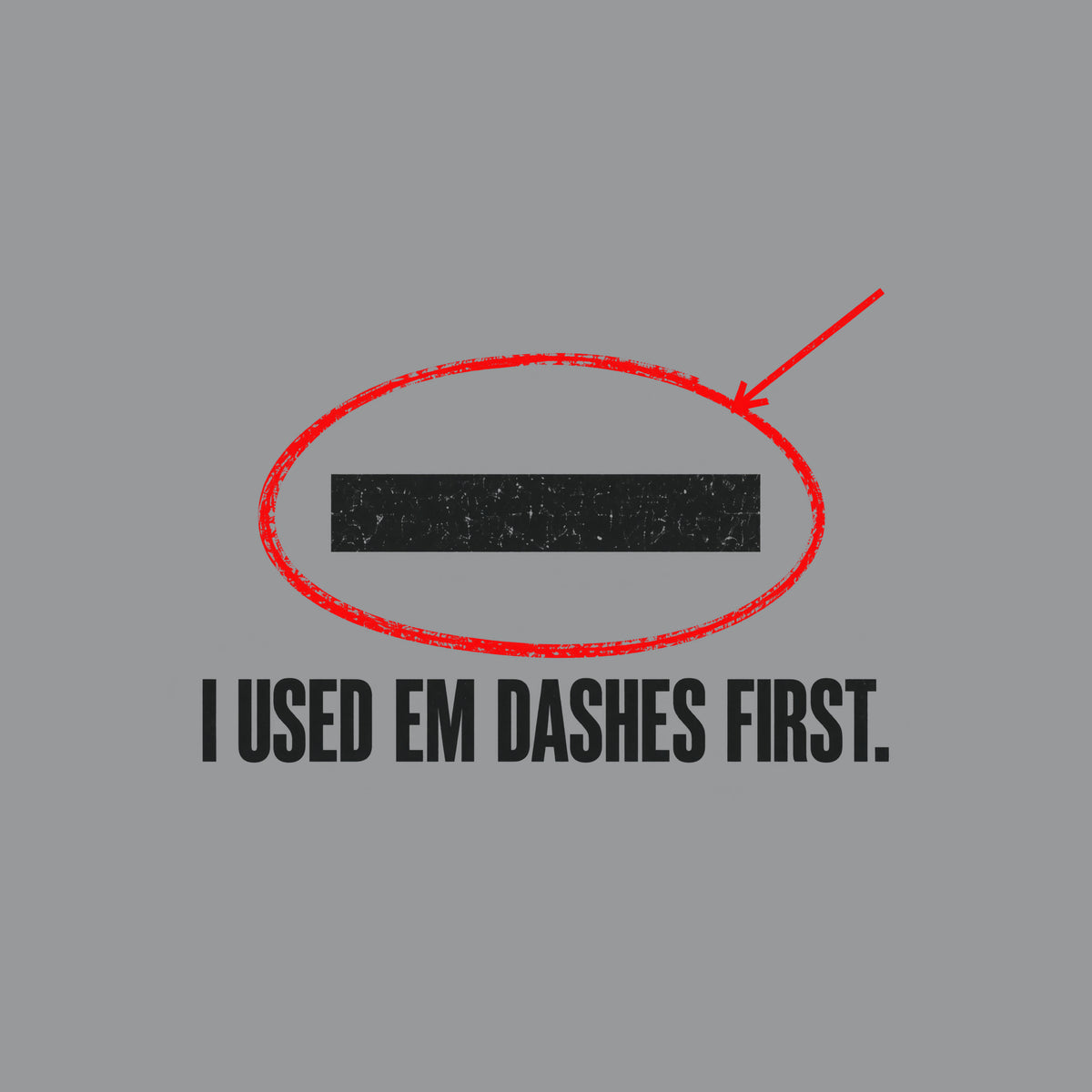 Navy artwork showing a cream em dash circled in red ink with a red leader line pointing to it, above bold cream uppercase text reading I USED EM DASHES FIRST. Artwork shown on the Sport Grey garment colour.