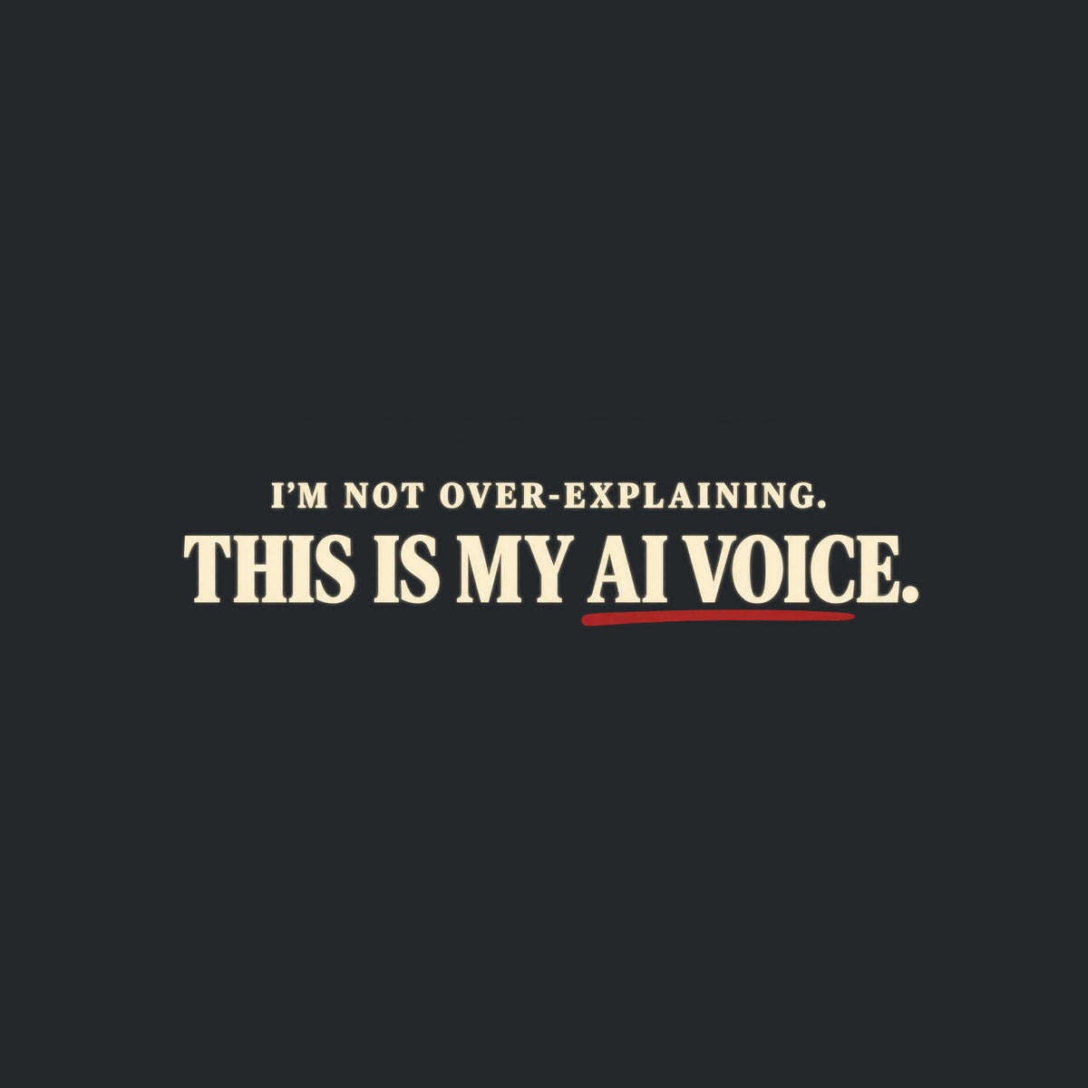 Black tee with cream text reading I'M NOT OVER-EXPLAINING. above larger bold text THIS IS MY AI VOICE. with a muted red underline beneath AI VOICE. Artwork shown on the Black garment colour.