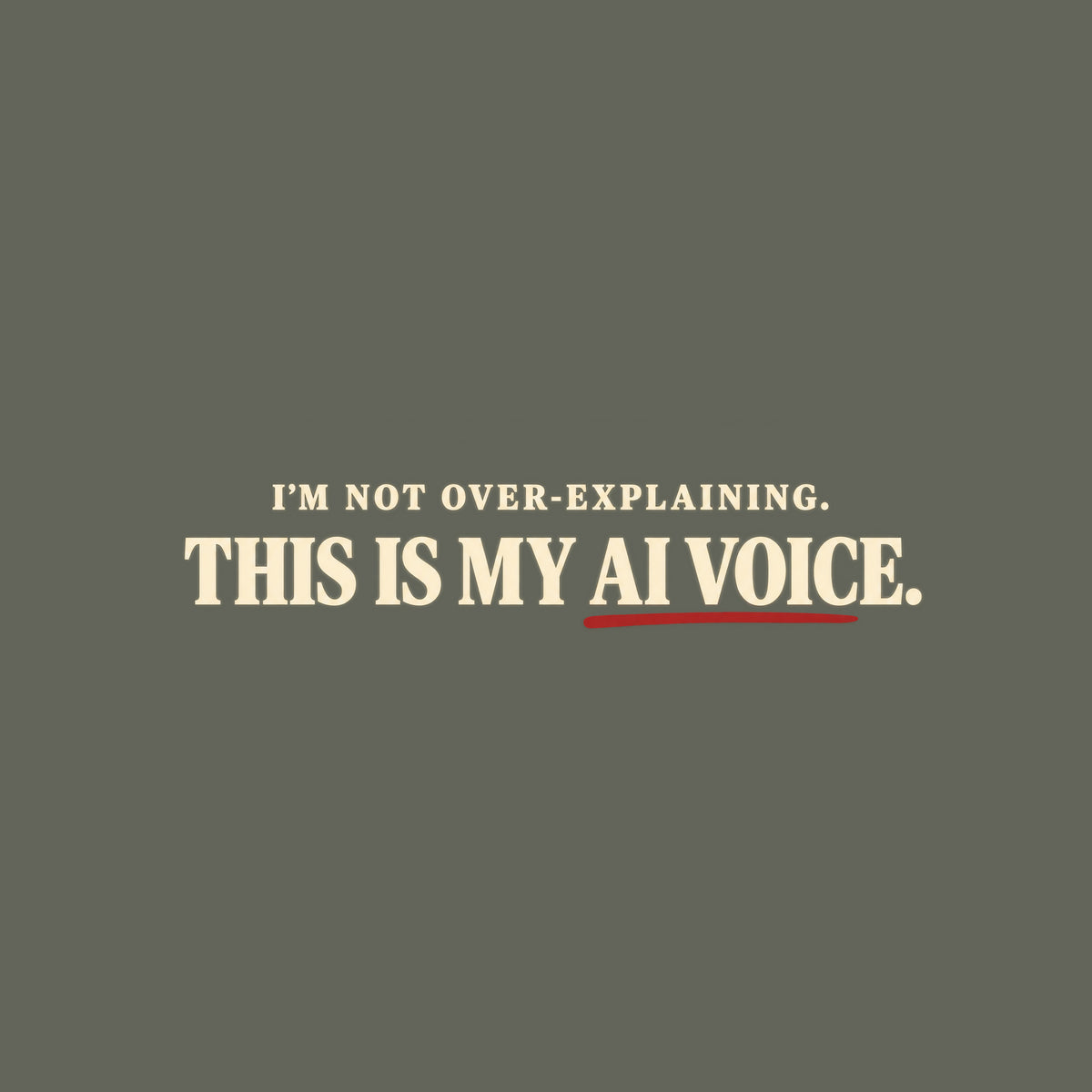 Black tee with cream text reading I'M NOT OVER-EXPLAINING. above larger bold text THIS IS MY AI VOICE. with a muted red underline beneath AI VOICE. Artwork shown on the Military Green garment colour.