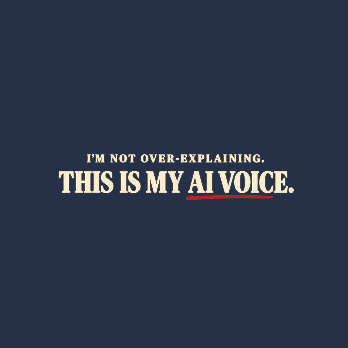 Black tee with cream text reading I'M NOT OVER-EXPLAINING. above larger bold text THIS IS MY AI VOICE. with a muted red underline beneath AI VOICE. Artwork shown on the Navy garment colour.