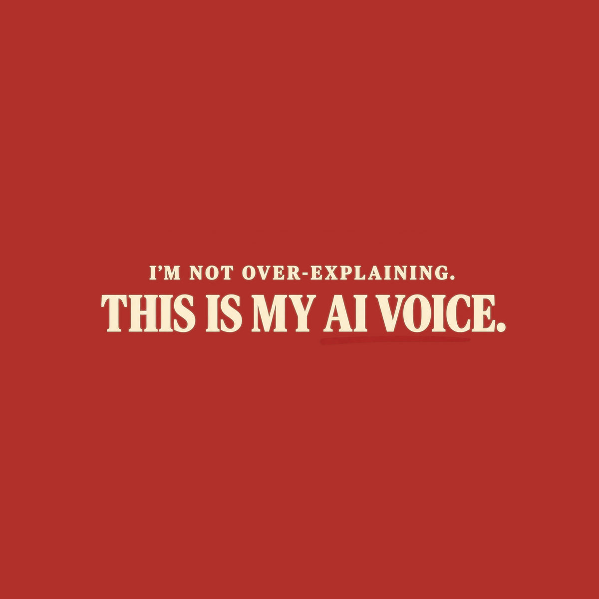 Black tee with cream text reading I'M NOT OVER-EXPLAINING. above larger bold text THIS IS MY AI VOICE. with a muted red underline beneath AI VOICE. Artwork shown on the Red garment colour.