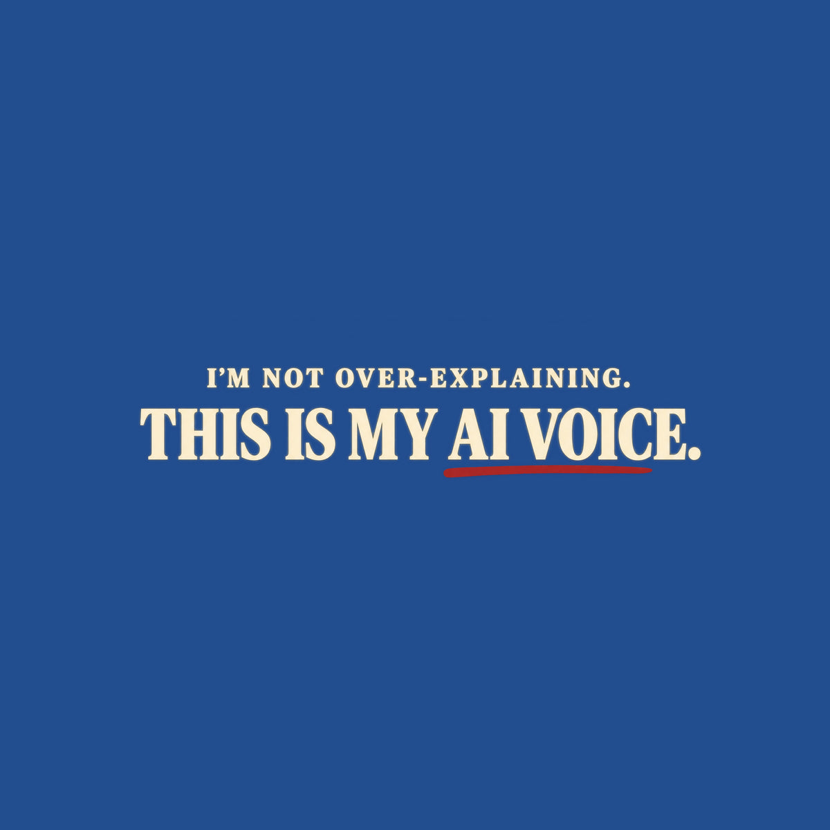 Black tee with cream text reading I'M NOT OVER-EXPLAINING. above larger bold text THIS IS MY AI VOICE. with a muted red underline beneath AI VOICE. Artwork shown on the Royal garment colour.