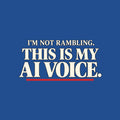 Black t-shirt graphic in cream serif type reading 'I'M NOT RAMBLING.' on a smaller line above the larger line 'THIS IS MY AI VOICE.', underlined once in muted red. Artwork shown on the Royal garment colour.