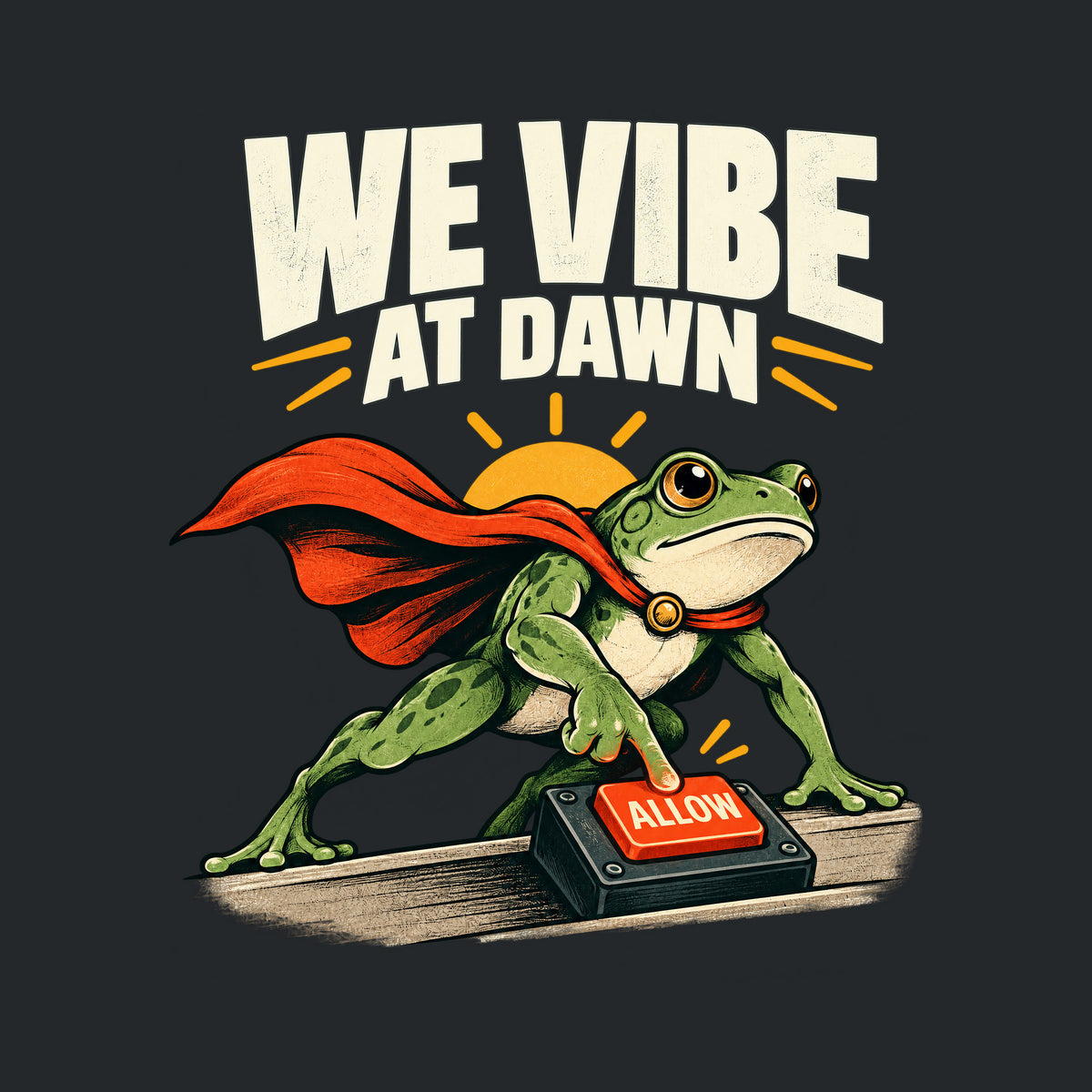 Illustration of a green frog in a red cape pressing a glowing red "ALLOW" button on a small desktop controller, with a rising sun behind it and the bold headline "WE VIBE AT DAWN" above, on a plain cream background. Artwork shown on the Black garment colour.
