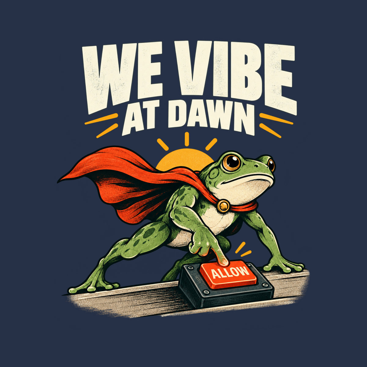 Illustration of a green frog in a red cape pressing a glowing red "ALLOW" button on a small desktop controller, with a rising sun behind it and the bold headline "WE VIBE AT DAWN" above, on a plain cream background. Artwork shown on the Navy garment colour.